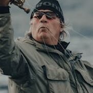 A man enjoying fly fishing in a scenic outdoor location, showcasing technique and passion.